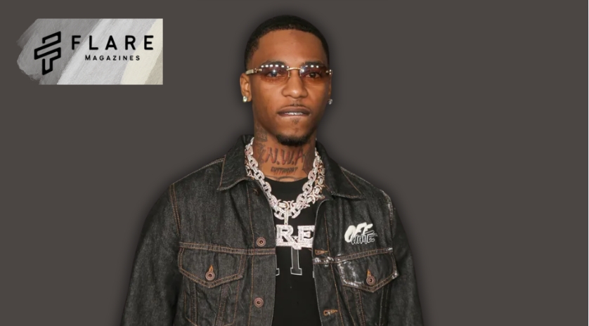 a man with a necklace and a black jacket